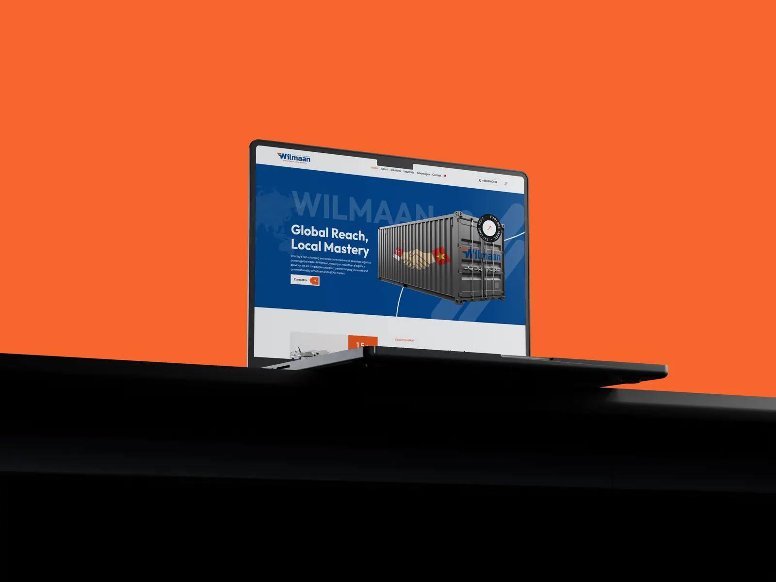 Hand holding a phone showing the Wilmaan interface with bold blue branding