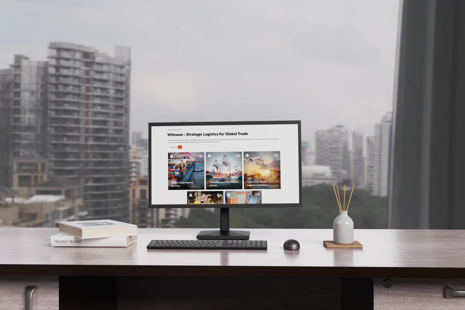 Desktop monitor mockup showing Wilmaan screens in a real workspace environment